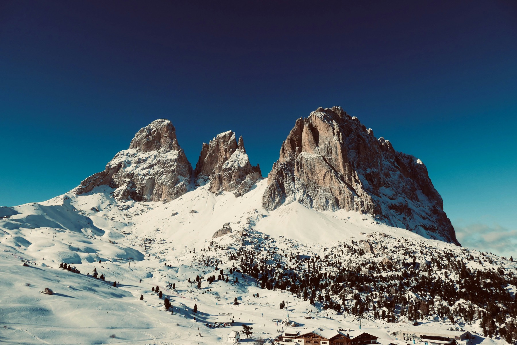 The Sassolungo towers above the snowfields