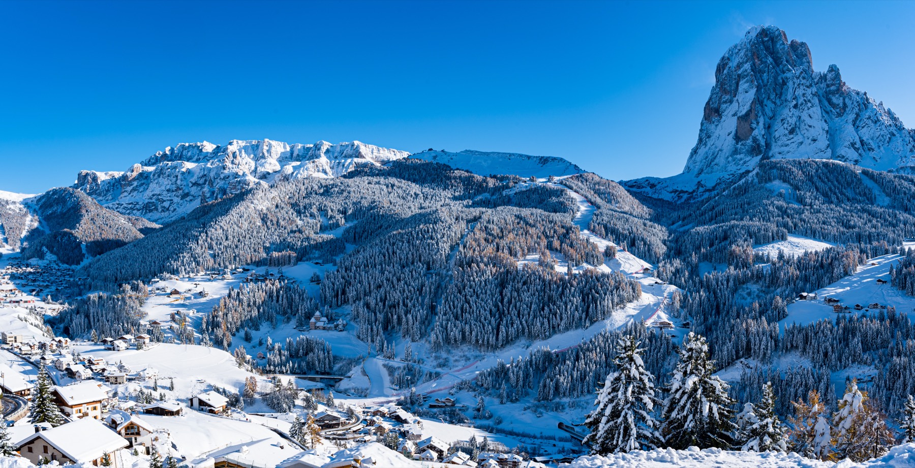 Val Gardena under fresh snow beneath the Sassolungo