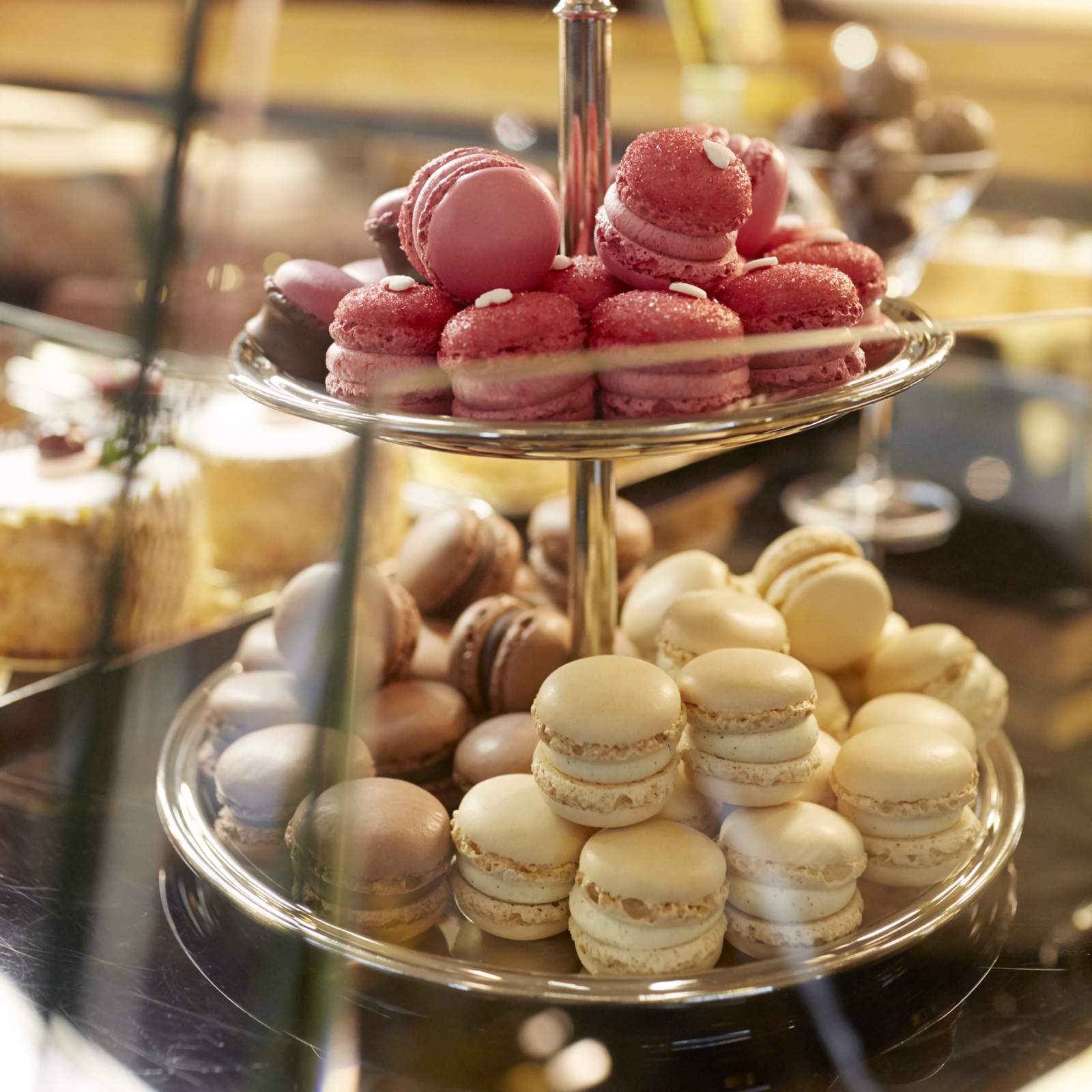 Luxemburgerli macarons stacked on a silver stand at Confiserie Sprüngli